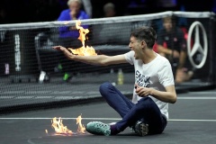 climate change protester sets arm on fire during laver cup match