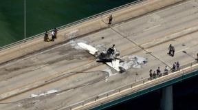 small plane crashes on bridge near miami striking an suv