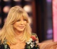goldie hawn dancing with a giant bottle of wine in her hand is the ultimate vacation vibe