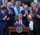 trump claims victory as he signs controversial budget and tax bill into law
