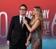 bobby bones and wife caitlin parker hold hands for acms entrance