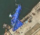 north korea raises capsized warship after botched launch report